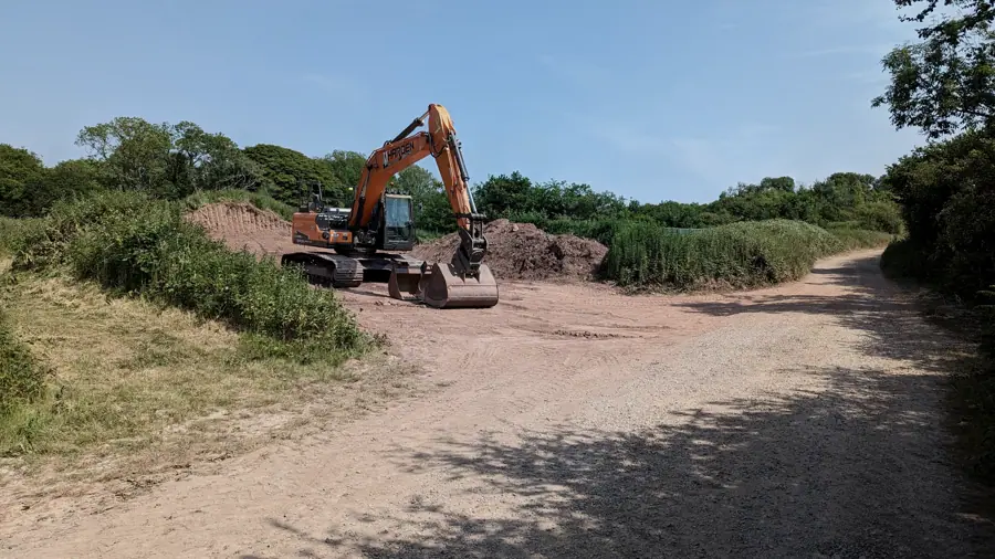 Excavator on a graded earthworks pad